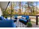 Relaxing back deck provides ample seating for entertaining with views of the surrounding trees at 994 Redbud Sw Ln, Atlanta, GA 30311