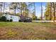 Spacious backyard with a deck, outdoor seating, and beautiful landscaping at 994 Redbud Sw Ln, Atlanta, GA 30311