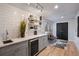 Chic bar area boasts floating shelves, a beverage cooler, and eye-catching tile backsplash at 994 Redbud Sw Ln, Atlanta, GA 30311