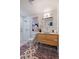Modern bathroom with decorative tile floor, wood vanity, and glass-enclosed shower at 994 Redbud Sw Ln, Atlanta, GA 30311