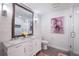 Bright bathroom boasts a double sink vanity, a large mirror, and a glass-enclosed shower at 994 Redbud Sw Ln, Atlanta, GA 30311