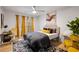 Cozy bedroom with a modern ceiling fan, stylish decor, and vibrant yellow accents at 994 Redbud Sw Ln, Atlanta, GA 30311