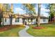 Charming white brick home features a well-manicured lawn and inviting walkway at 994 Redbud Sw Ln, Atlanta, GA 30311