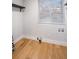 Empty laundry room with wood flooring, shelves, and a window at 994 Redbud Sw Ln, Atlanta, GA 30311
