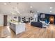 Open concept living space with kitchen island, modern lighting, and hardwood floors at 994 Redbud Sw Ln, Atlanta, GA 30311