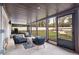 Enclosed sunroom with modern furniture and views of the backyard at 994 Redbud Sw Ln, Atlanta, GA 30311