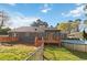 This backyard features a fenced yard, deck, pergola, and above ground pool at 1354 Litchfield Ct, Snellville, GA 30078