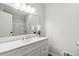 Modern bathroom with white vanity, sink, mirror, and a shower-tub combo at 1354 Litchfield Ct, Snellville, GA 30078