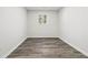 A bright room with gray wood-look floors and a window letting in natural light at 1354 Litchfield Ct, Snellville, GA 30078