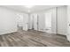 Large bedroom with multiple doors, neutral gray paint, and gray wood flooring at 1354 Litchfield Ct, Snellville, GA 30078