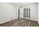 This bedroom includes sliding closet doors, wood-look flooring, and neutral walls at 1354 Litchfield Ct, Snellville, GA 30078