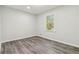 Bright room with gray wood-look floors and a window letting in natural light at 1354 Litchfield Ct, Snellville, GA 30078