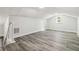 This bonus room offers natural light, neutral walls, and wood-look flooring at 1354 Litchfield Ct, Snellville, GA 30078