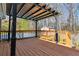 This deck features a pergola, wooden railings, and a view of the backyard and pool at 1354 Litchfield Ct, Snellville, GA 30078