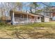 Charming single-story home with a welcoming front porch, red door, and well-maintained lawn exudes curb appeal at 1354 Litchfield Ct, Snellville, GA 30078