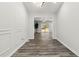 Hallway with hardwood floors leading to a bright living area with backyard access at 1354 Litchfield Ct, Snellville, GA 30078