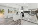 Bright kitchen with white cabinets, stainless appliances, granite counters, and gray wood floors at 1354 Litchfield Ct, Snellville, GA 30078