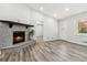 Bright living room with hardwood floors, stone fireplace, and a front door for easy access at 1354 Litchfield Ct, Snellville, GA 30078