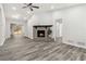Open-concept living room featuring hardwood floors, a cozy fireplace, and access to a backyard deck for easy indoor-outdoor living at 1354 Litchfield Ct, Snellville, GA 30078