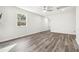Spacious living room with ceiling fan, window with backyard view, and gray wood-look floors at 1354 Litchfield Ct, Snellville, GA 30078