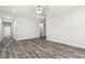 View of living room with gray wood-look floors and white walls, with hallway access at 1354 Litchfield Ct, Snellville, GA 30078