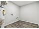 Unfinished laundry room with modern floors and utility connections at 1354 Litchfield Ct, Snellville, GA 30078