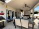 Inviting outdoor dining space on a covered back porch with comfortable seating and a ceiling fan at 197 Buckhorn Dr, Temple, GA 30179