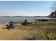 Backyard area with furniture, lawn and palm trees, embankment with lovely view of the lake and trees at 197 Buckhorn Dr, Temple, GA 30179