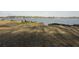 Backyard with view of the lake, lawn, concrete embankment and various chairs to enjoy the scene at 197 Buckhorn Dr, Temple, GA 30179