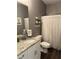 Stylish bathroom features granite countertops, a modern vanity, and a shower with elegant macrame curtains at 197 Buckhorn Dr, Temple, GA 30179