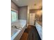 Stylish bathroom with tub, white subway tile, and granite countertop vanity at 197 Buckhorn Dr, Temple, GA 30179