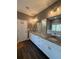 Granite countertops, double sinks, and large mirrors accent this luxurious bathroom at 197 Buckhorn Dr, Temple, GA 30179