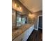 Granite countertop vanity, double sinks, and large mirror in the stylish bathroom at 197 Buckhorn Dr, Temple, GA 30179
