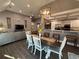 Open dining area with modern light fixture, seamlessly connected to the living room and kitchen at 197 Buckhorn Dr, Temple, GA 30179