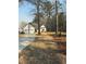 Charming home with a two-car garage, mature trees, and a well-manicured lawn at 197 Buckhorn Dr, Temple, GA 30179
