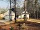 Charming home featuring a well-maintained lawn, attached garage, and inviting front porch with a bench at 197 Buckhorn Dr, Temple, GA 30179