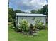 Outdoor view of white storage building with silver roof surrounded by garden landscape at 197 Buckhorn Dr, Temple, GA 30179