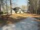 Exterior view of a charming home, showcasing the driveway, side yard and convenient lake access nearby at 197 Buckhorn Dr, Temple, GA 30179