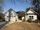 Attractive one story home featuring an attached garage, a lovely front porch, and manicured landscaping at 197 Buckhorn Dr, Temple, GA 30179