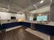 Modern kitchen featuring white upper cabinets, blue lower cabinets, and stainless steel appliances at 197 Buckhorn Dr, Temple, GA 30179