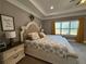 Elegant main bedroom boasts tray ceilings, soft carpeting, and a serene, inviting atmosphere at 197 Buckhorn Dr, Temple, GA 30179