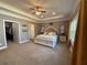 Spacious main bedroom featuring tray ceilings, a ceiling fan, and an ensuite bathroom at 197 Buckhorn Dr, Temple, GA 30179