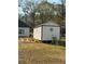 White shed with black trim in backyard with flamingo decor at 197 Buckhorn Dr, Temple, GA 30179