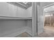 The bathroom has a glass shower enclosure next to a walk-in closet with shelving at 2094 Callaway Nw Ct, Atlanta, GA 30318