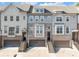 Charming townhome exterior with brick accents, attached garages, and inviting staircases at 2094 Callaway Nw Ct, Atlanta, GA 30318