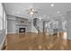 Open-concept living room with stone fireplace flows seamlessly into kitchen and staircase at 2094 Callaway Nw Ct, Atlanta, GA 30318