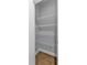 Walk-in pantry with white wire shelving and light wood floor at 2094 Callaway Nw Ct, Atlanta, GA 30318