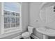 Modern powder room featuring a pedestal sink and a round mirror at 2094 Callaway Nw Ct, Atlanta, GA 30318