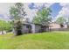 Expansive backyard with lush green lawn and mature trees offering shade at 332 Cheryl Ct, Jonesboro, GA 30238