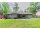 Well-maintained backyard featuring a covered patio and mature trees at 332 Cheryl Ct, Jonesboro, GA 30238